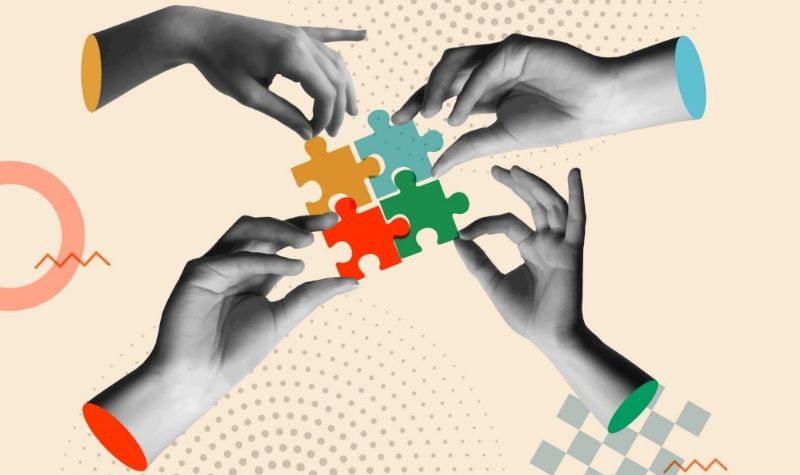 vector image of four hands holding puzzle pieces together 